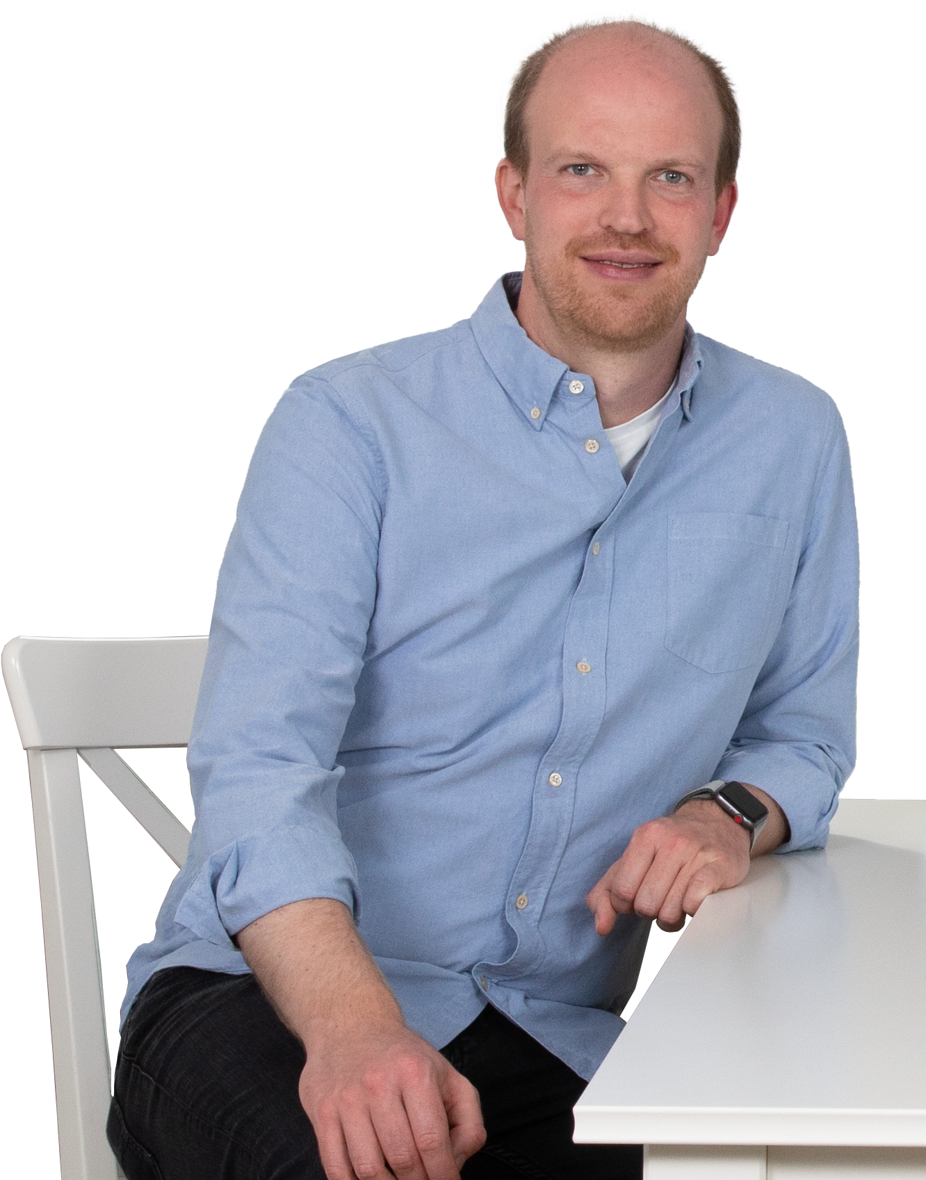 Thomas Iversen sits next to a desk